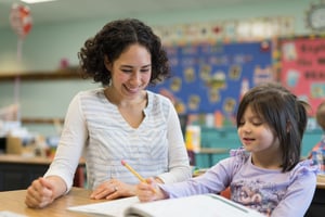 teacher-with-student-at-desk