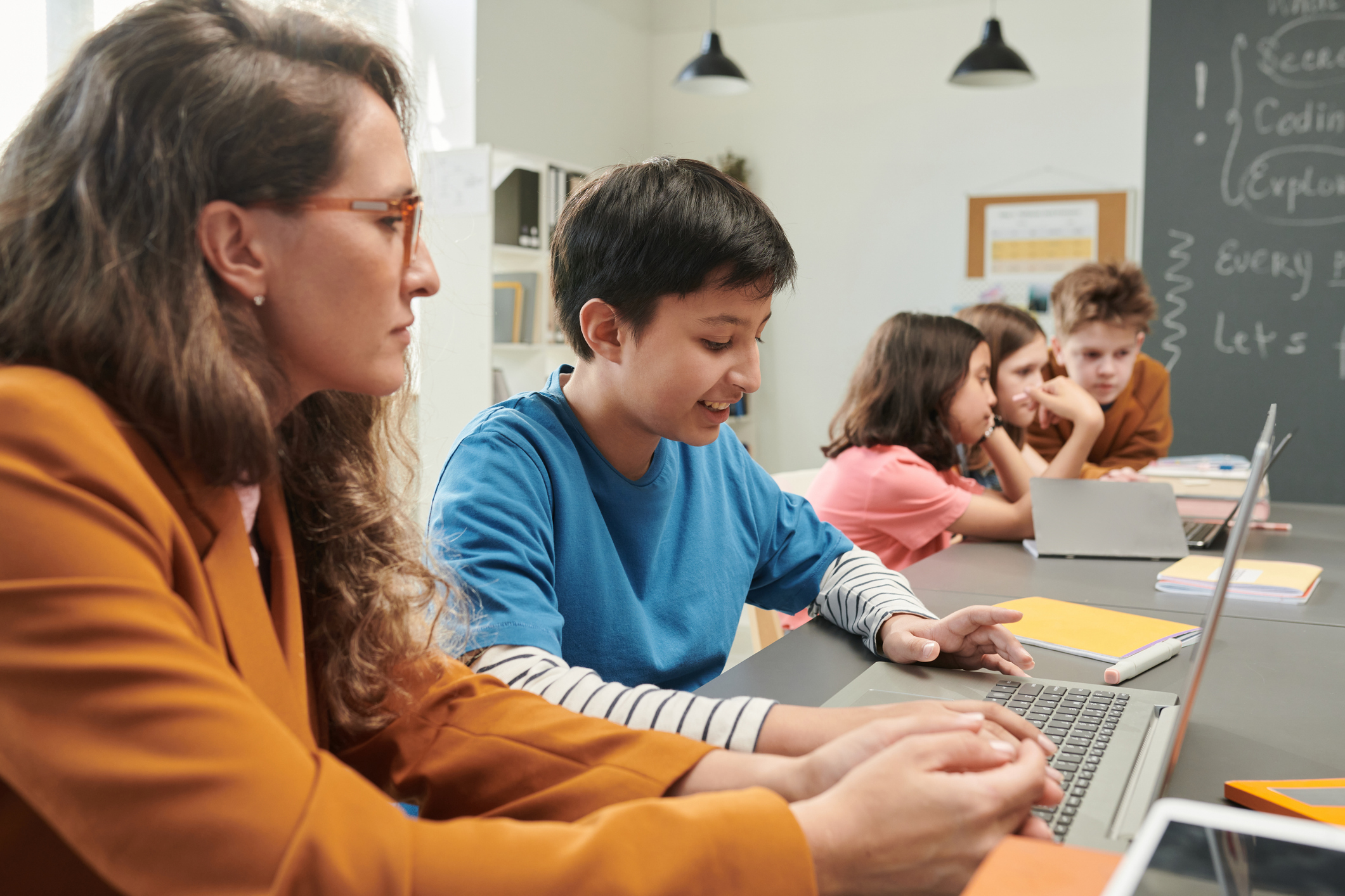 Teacher working with student in testing lab. 